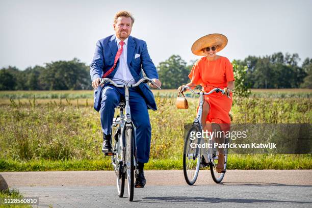 King Willem-Alexander of The Netherlands and Queen Maxima of The Netherlands ride on bicycles as they visit ECOstyle, Biosintrum and EcoMinutypark...