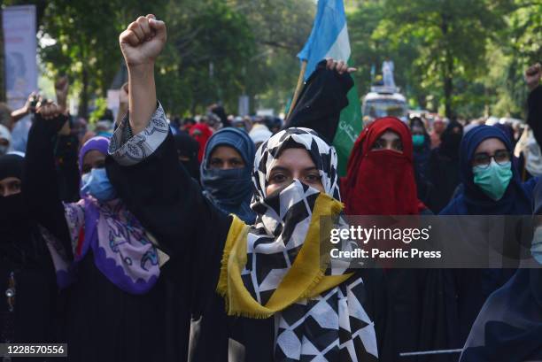 Pakistani supporters of Islamic political party Jamaat-e-Islami march during protest against an alleged gang rape of a woman in front of her three...