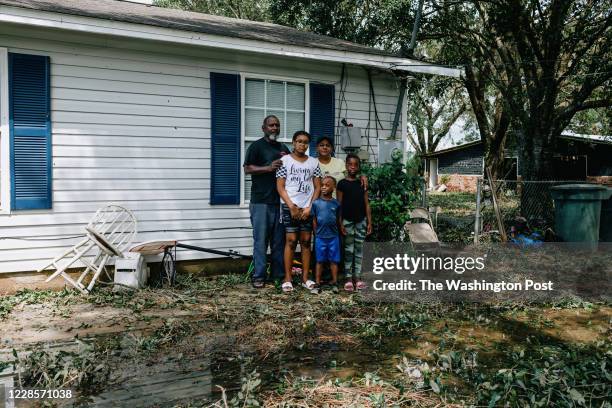 Wendy Evil and her fiance Kenneth Gibbes pose in front of their Wedgwood home with Evils grandchildren Bobbiana Lockhart Aykirah Ball and Akeviyan...