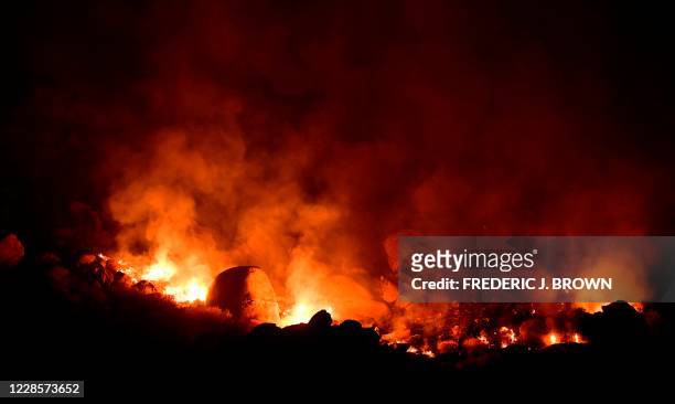 Flames from the Snow Fire burn in the San Jacinto Mountains leading to evacuations of the the community of Snow Creek early on September 18 west of...