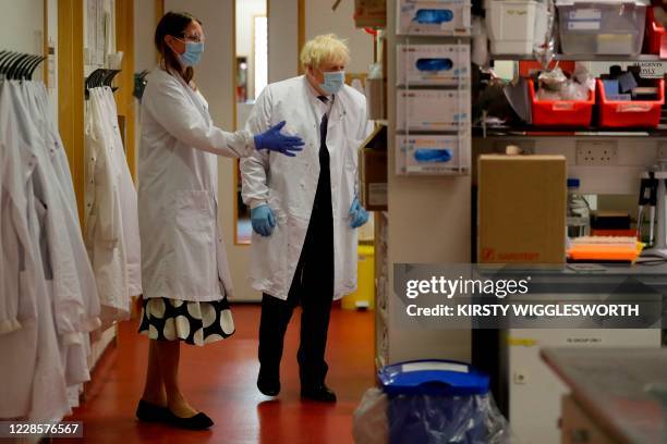 Britain's Prime Minister Boris Johnson is shown around by Professor Kate Ewer, Senior Immunologist during a visit to the Jenner Institute in Oxford,...