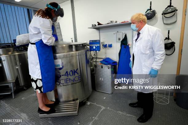 Britain's Prime Minister Boris Johnson is shown samples stored in liquid nitrogen by Professor Kate Ewer, Senior Immunologist, during a visit to the...