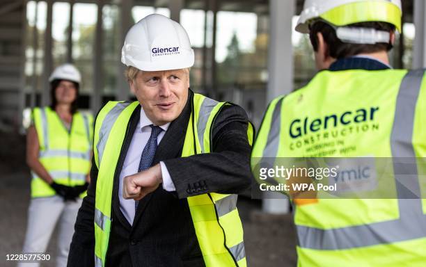 Prime Minister Boris Johnson bumps elbows with scientists as he visits the construction site of the new vaccines Manufacturing and Innovation Centre...