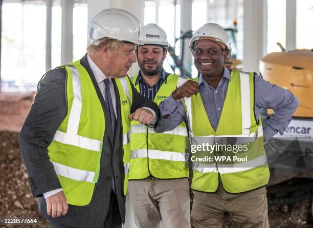 Prime Minister Boris Johnson bumps elbows with construction workers as he visits the construction site of the new vaccines Manufacturing and...