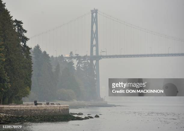 Stanley Park and Lions Gate Bridge are covered in smog from clouds and smoke due to forest fires in Washington, Oregon and California, September 17...