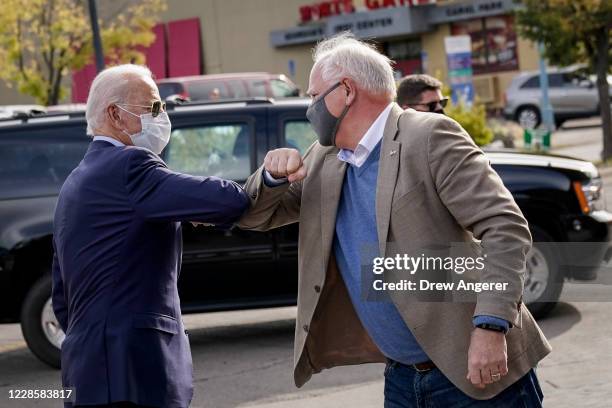 Democratic presidential nominee and former Vice President Joe Biden bumps elbows with Minnesota Governor Tim Walz as he arrives at Amazing Grace...