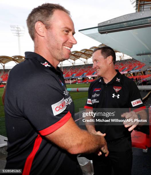 Ben Rutten, Senior Assistant Coach and Team Defence of the Bombers and John Worsfold, Senior coach shake hands after the 2020 AFL Round 18 match...