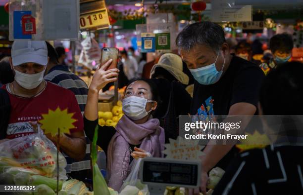 Chinese customer uses her mobile to scan a QR code while paying with the WeChat app at a local market on September 19, 2020 in Beijing, China. The...