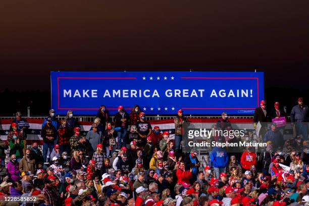 Supporters look on as President Donald Trump speaks during a rally at the Bemidji Regional Airport on September 18, 2020 in Bemidji, Minnesota. Trump...