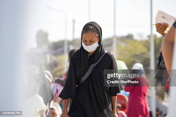 Thousands of asylum seekers are seen in queues waiting to register and enter the new temporary refugee camp in Lesbos island in Greece after the fire...