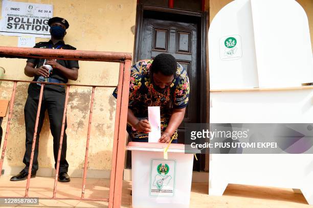 Woman casts her ballot at a polling station during the Edo State governorship elections in Benin City, Midwestern Nigeria, on September 19, 2020. -...
