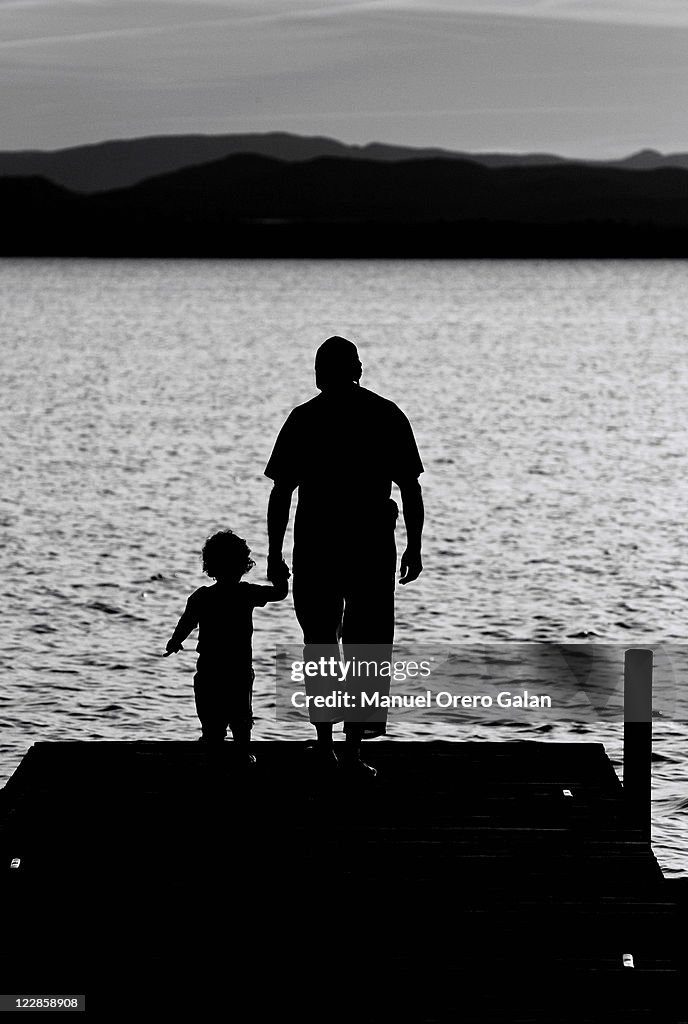 Father and son standing on dock