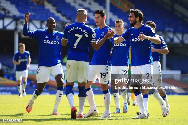 James Rodriguez and Andre Gomes of Everton celebrate with Richarlison who provided the assist for their 4th goal during the Premier League match...