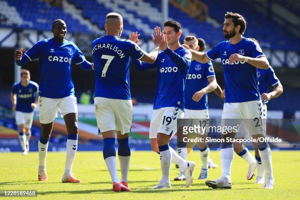 James Rodriguez and Andre Gomes of Everton celebrate with Richarlison who provided the assist for their 4th goal during the Premier League match...