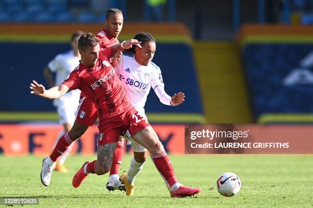 Fulham's English defender Joe Bryan vies with Leeds United's Portuguese midfielder Helder Costa during the English Premier League football match...