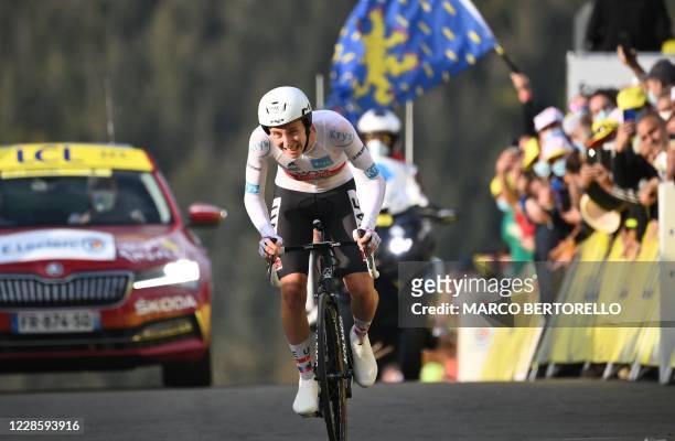 Team UAE Emirates rider Slovenia's Tadej Pogacar wearing the best young's white jersey crosses the finish line at the end of the 20th stage of the...