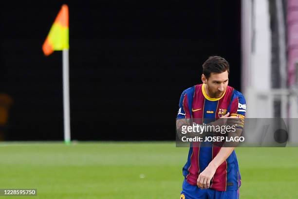 Barcelona's Argentinian forward Lionel Messi touches his captain's armband during the 55th Joan Gamper Trophy friendly football match between...