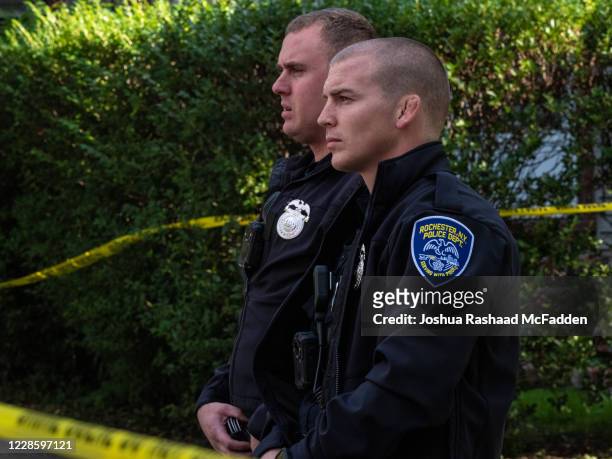 Police officers investigate a crime scene after a shooting at a backyard party on September 19 Rochester, New York. Two young adults - a man and a...