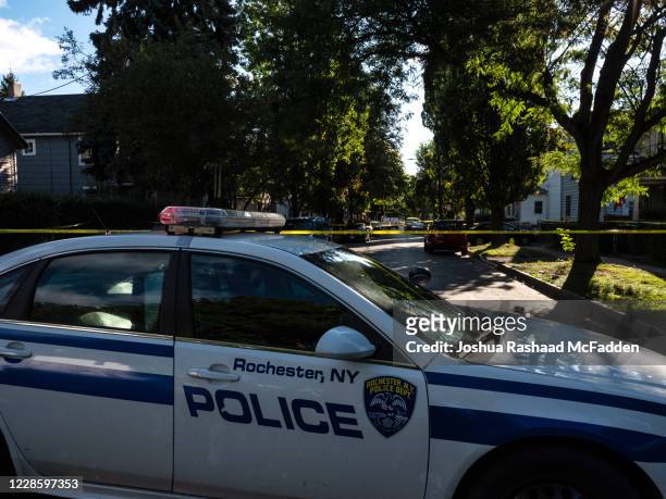 Police tape lines a crime scene after a shooting at a backyard party on September 19 Rochester, New York. Two young adults - a man and a woman - were...