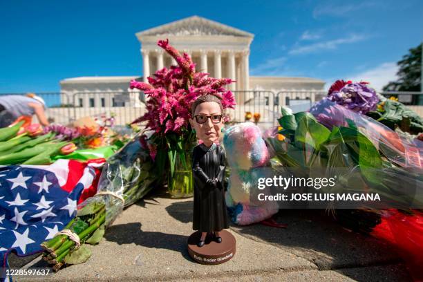 Bobblehead of US Supreme Court Justice Ruth Bader Ginsburg is left outside of the US Supreme Court in Washington, DC, on September 19, 2020. -...