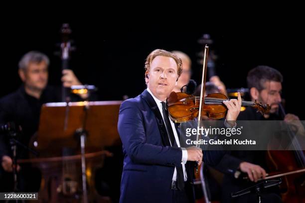 British classical violinist Daniel Hope performs a piece of Max Richter, Vivaldi Recomposed on a floating stage on the Vltava river on September 19...