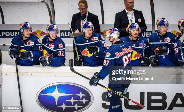 Philip Gogulla of EHC Red Bull Muenchen celebrates the goal to 2:1 with the players on the bench during the test match between EHC Red Bull Munich...