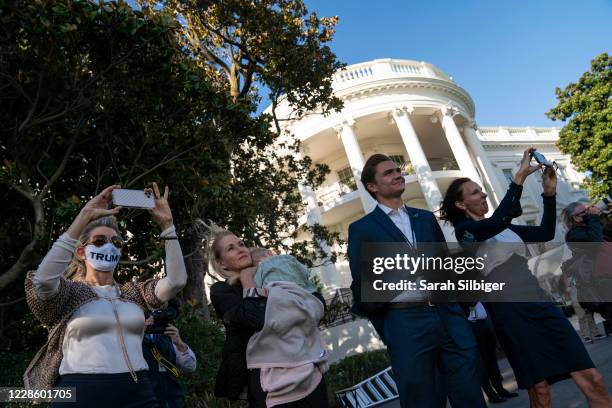 Supporters watch as U.S. President Donald Trump departs from the White House on September 19, 2020 in Washington, DC. President Trump is traveling to...