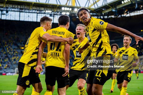 Giovanni Reyna with Jude Bellingham and Thomas Meunier , Erling Haaland cheers after scoring his team's opening goal during the Bundesliga match...