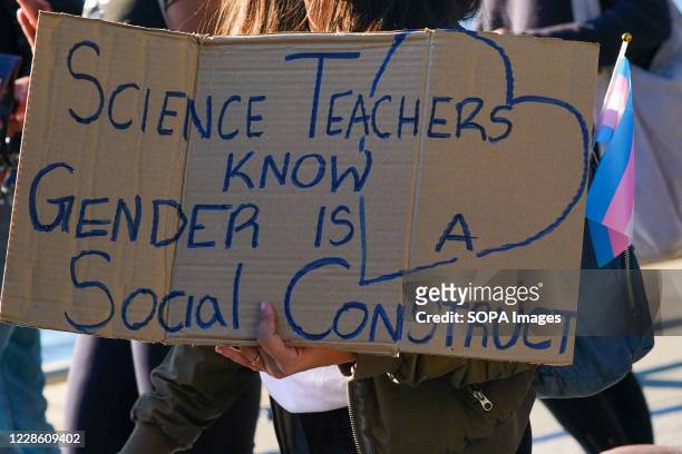 Protester holds a placard that says, 'Science teacher know Gender is a Social Construct' during a Black Trans Lives Matter rally in Hudson River Park.