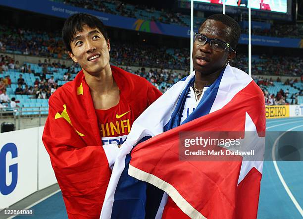 Dayron Robles of Cuba celebrates with Xiang Liu of China after the men's 110 metres hurdles final during day three of the 13th IAAF World Athletics...