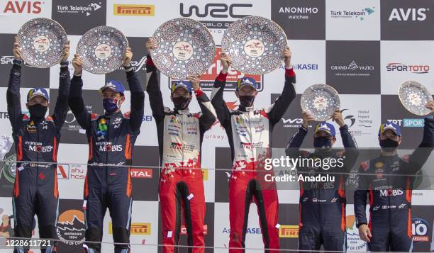 1st place winner Britain's Elfyn Evans of Red Bull, 2nd place winner Belgian Thierry Neuville and 3rd place winner Sebastien Loeb hold their awards...