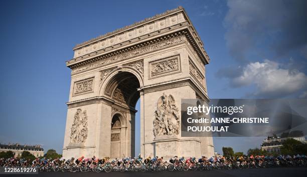 The pack rides around the Arc de Triomphe during the 21st and last stage of the 107th edition of the Tour de France cycling race, 122 km between...