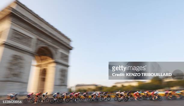 The pack rides around the Arc de Triomphe during the 21st and last stage of the 107th edition of the Tour de France cycling race, 122 km between...