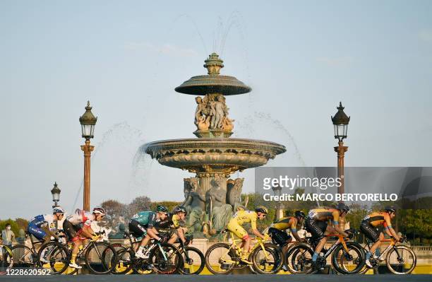 The pack rides on Concorde square during the 21st and last stage of the 107th edition of the Tour de France cycling race, 122 km between...