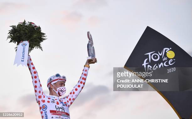 Team UAE Emirates rider Slovenia's Tadej Pogacar celebrates on the podium after winning the best climber's polka dot jersey of the 107th edition of...