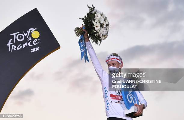 Team UAE Emirates rider Slovenia's Tadej Pogacar celebrates on the podium after winning the white jersey of best young of the 107th edition of the...