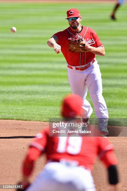 Mike Moustakas of the Cincinnati Reds throws to first baseman Joey Votto of the Cincinnati Reds in the second inning against the Chicago White Sox at...