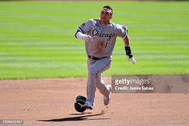 Nick Madrigal of the Chicago White Sox loses his helmet while running to third base in the first inning against the Cincinnati Reds at Great American...