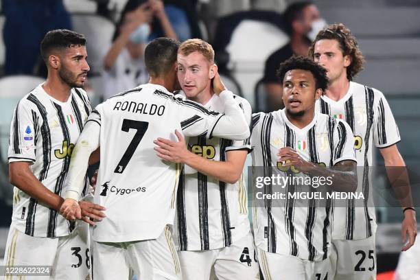 Juventus' Portuguese forward Cristiano Ronaldo embraces Juventus' Swedish forward Dejan Kulusevski after Kulusevski opened the scoring during the...