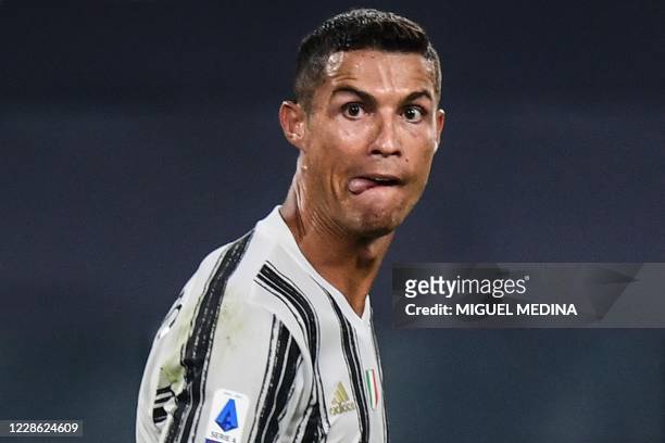 Juventus' Portuguese forward Cristiano Ronaldo looks on as he scores his team's third goal during the Italian Serie A football match Juventus vs...