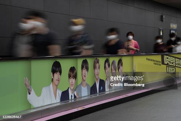 An advertisement for K-pop boy band BTS is displayed on a travelator at a subway station in Seoul, South Korea, on Friday, Sept. 18. 2020. Big Hit...