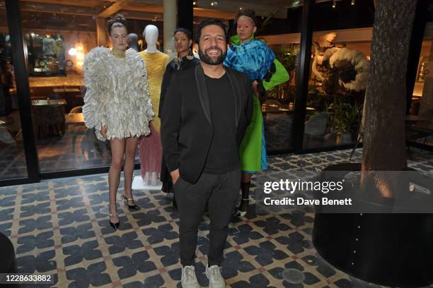 Osman Yousefzada poses with models at the OSMAN presentation during London Fashion Week September 2020 at The Mandrake Hotel on September 21, 2020 in...