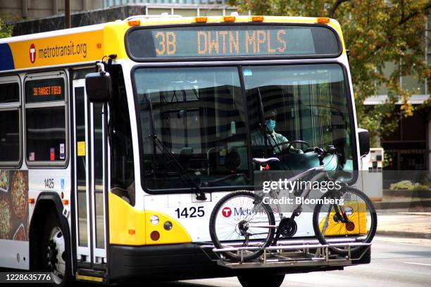 Driver wears a protective mask while driving a public bus in downtown Minneapolis, Minnesota, U.S., on Sunday, Sept. 20, 2020. In 2020, the pandemic...