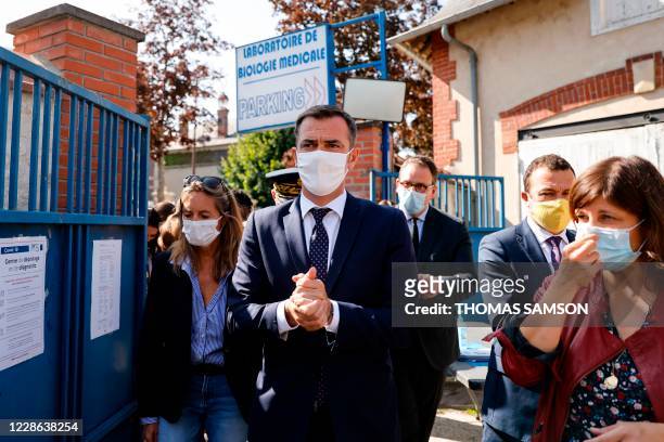 French Health Minister Olivier Veran wearing a protective mask arrives during a temporary Covid-19 screening facility in Mantes-la-Jolie, a suburb of...