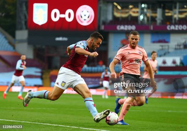 Aston Villa's Scottish midfielder John McGinn runs with the ball past Sheffield United's English defender Jack O'Connell during the English Premier...