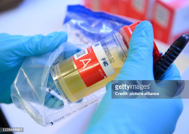 September 2020, Saxony, Kreischa: A laboratory technician at the Institute for Doping Analysis and Sport Biochemistry retrieves an athlete's urine...