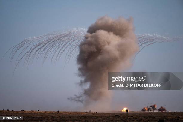 Smoke rises after an airstrike by Russian fighter jets at the Ashuluk military base in Southern Russia on September 22, 2020 during the...