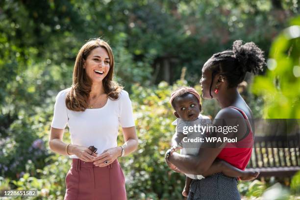 Catherine, Duchess of Cambridge meets with MUSH mother and baby group member, Morgan Alex Cassius and her 6 month old, Makena Grace as she hears from...