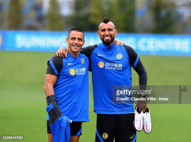 Alexis Sanchez and Arturo Vidal of FC Internazionale pose for a photo during a training session at Appiano Gentile on September 22, 2020 in Como,...