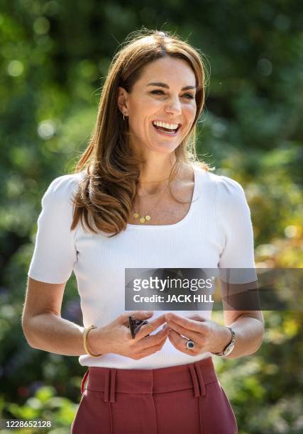 Britain's Catherine, Duchess of Cambridge, reacts as she meets with parents and children, and peer supporters, in Battersea Park, London on September...
